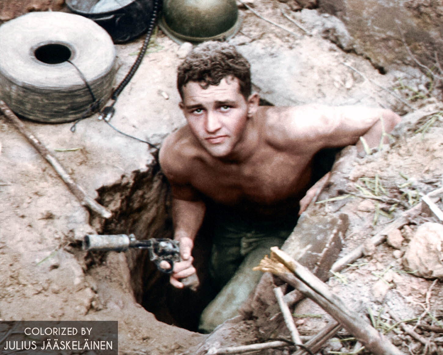 An American "tunnel rat" about to enter a Viet cong tunnel with a suppressed revolver, Vietnam 1960's